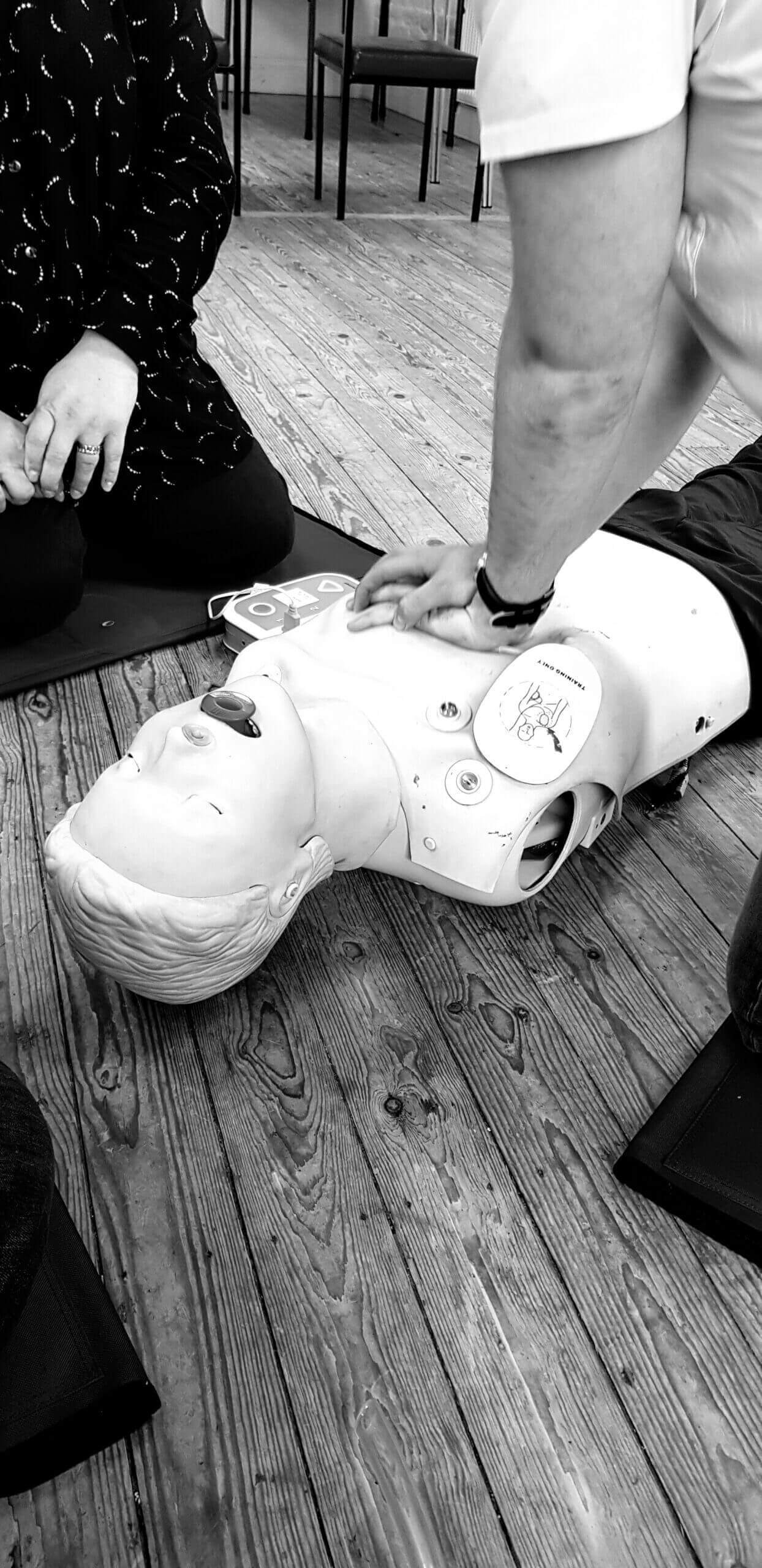 Restart a Heart Month CPR training - person performing chest compression's during life-saving first aid demonstration